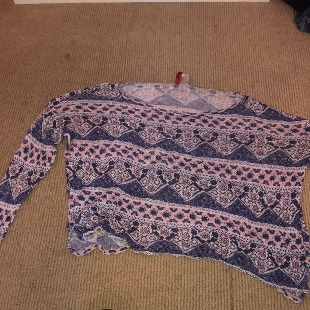 A dark blue sweater with white and pink designs